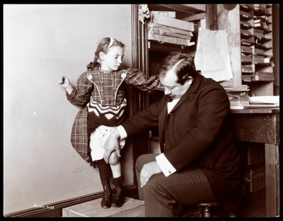 Professor Atkinson, an English bone setter, with a young female patient, 1898 by Byron Company